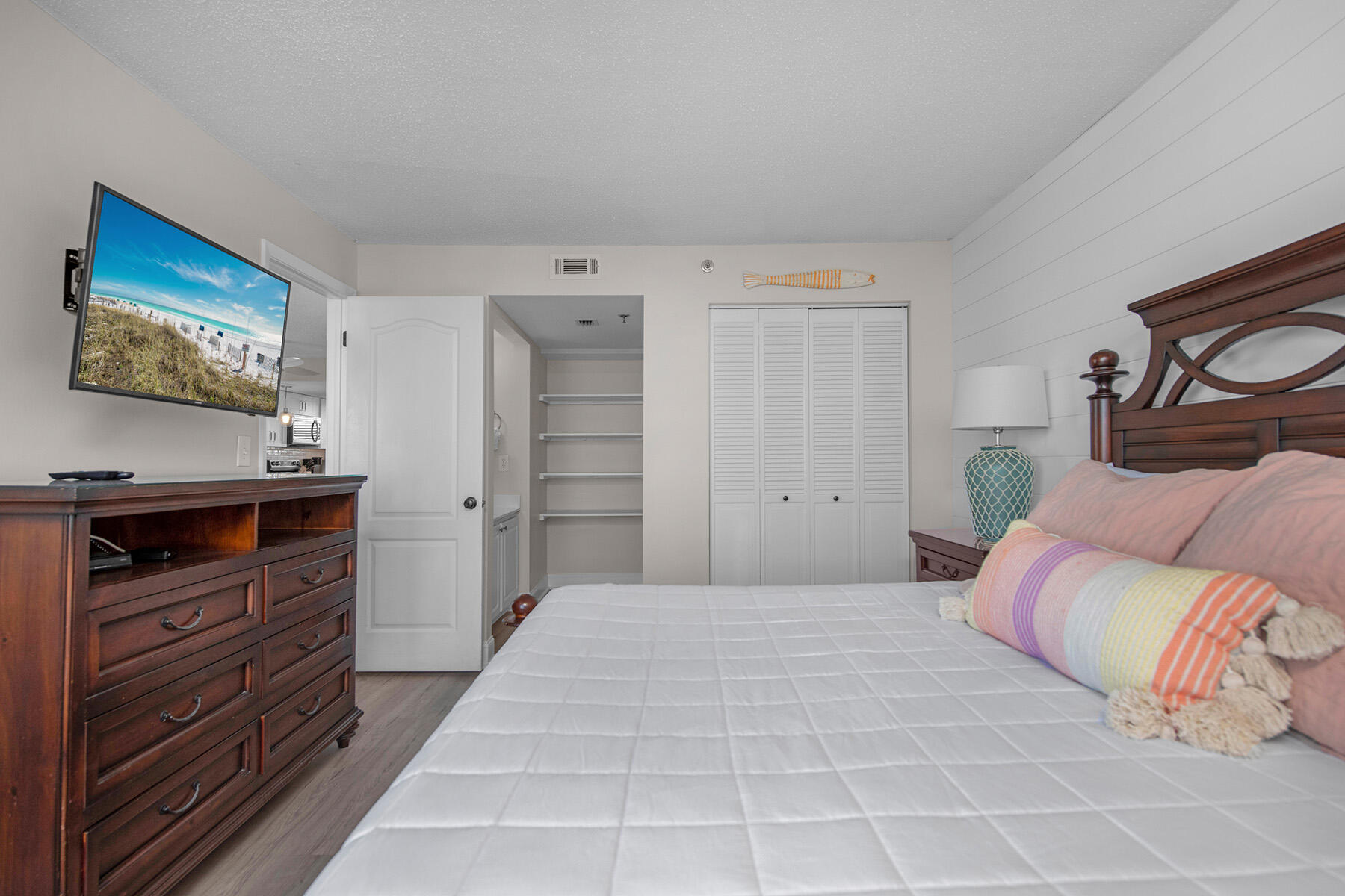 1040 Highway 98, Unit 518 Destin, FL 32541 - Photo 23 of 40 a bedroom with a bed and a flat screen tv