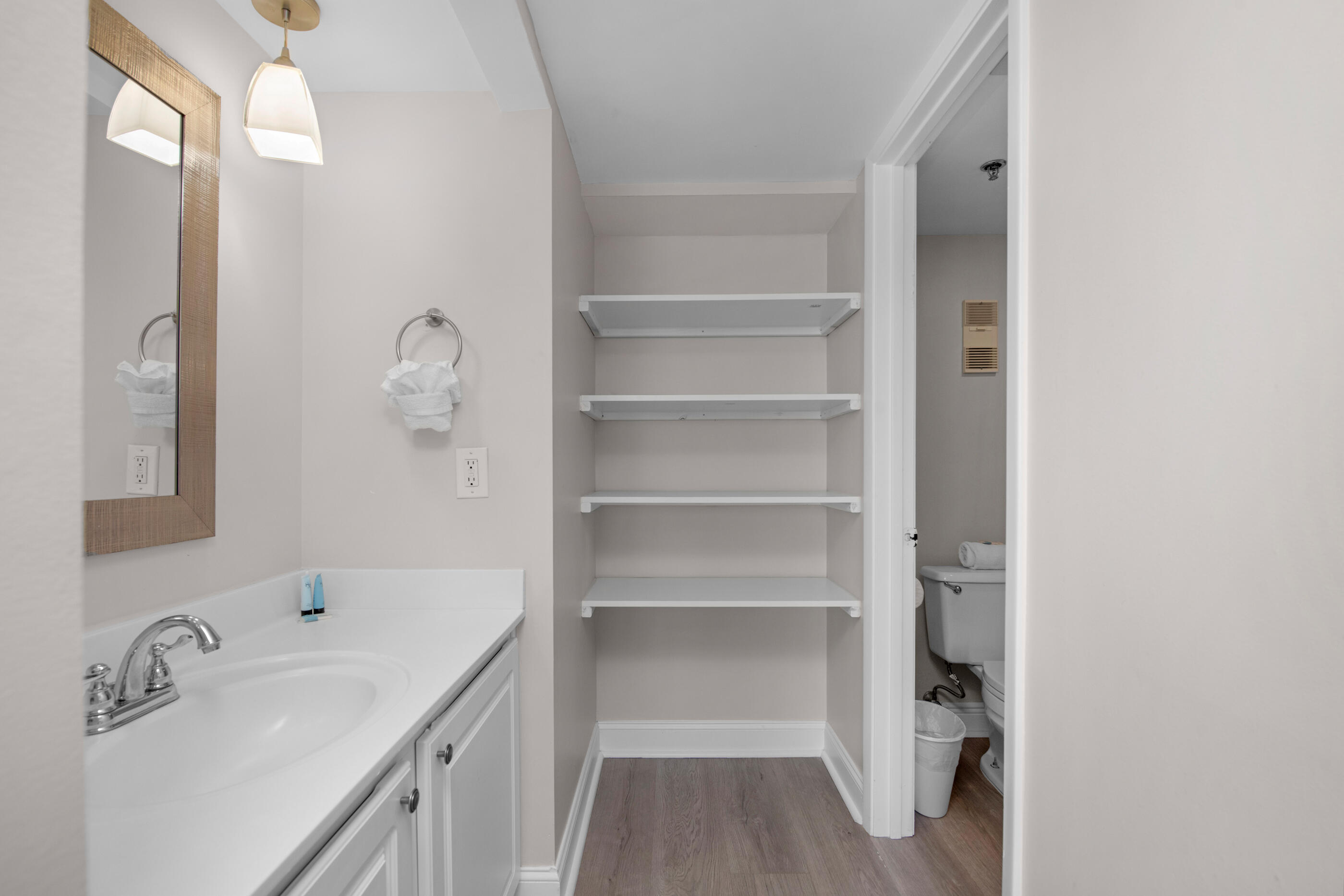 1040 Highway 98, Unit 518 Destin, FL 32541 - Photo 25 of 40 a bathroom with a sink a mirror and shower