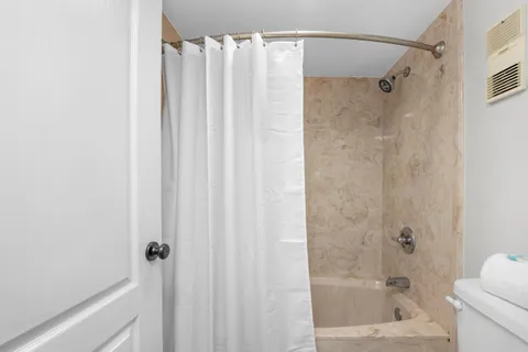 a bathroom with a shower and a tub