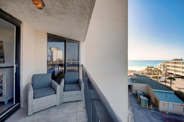 a balcony with furniture and a potted plant