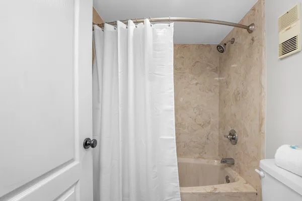 a bathroom with a shower and a tub