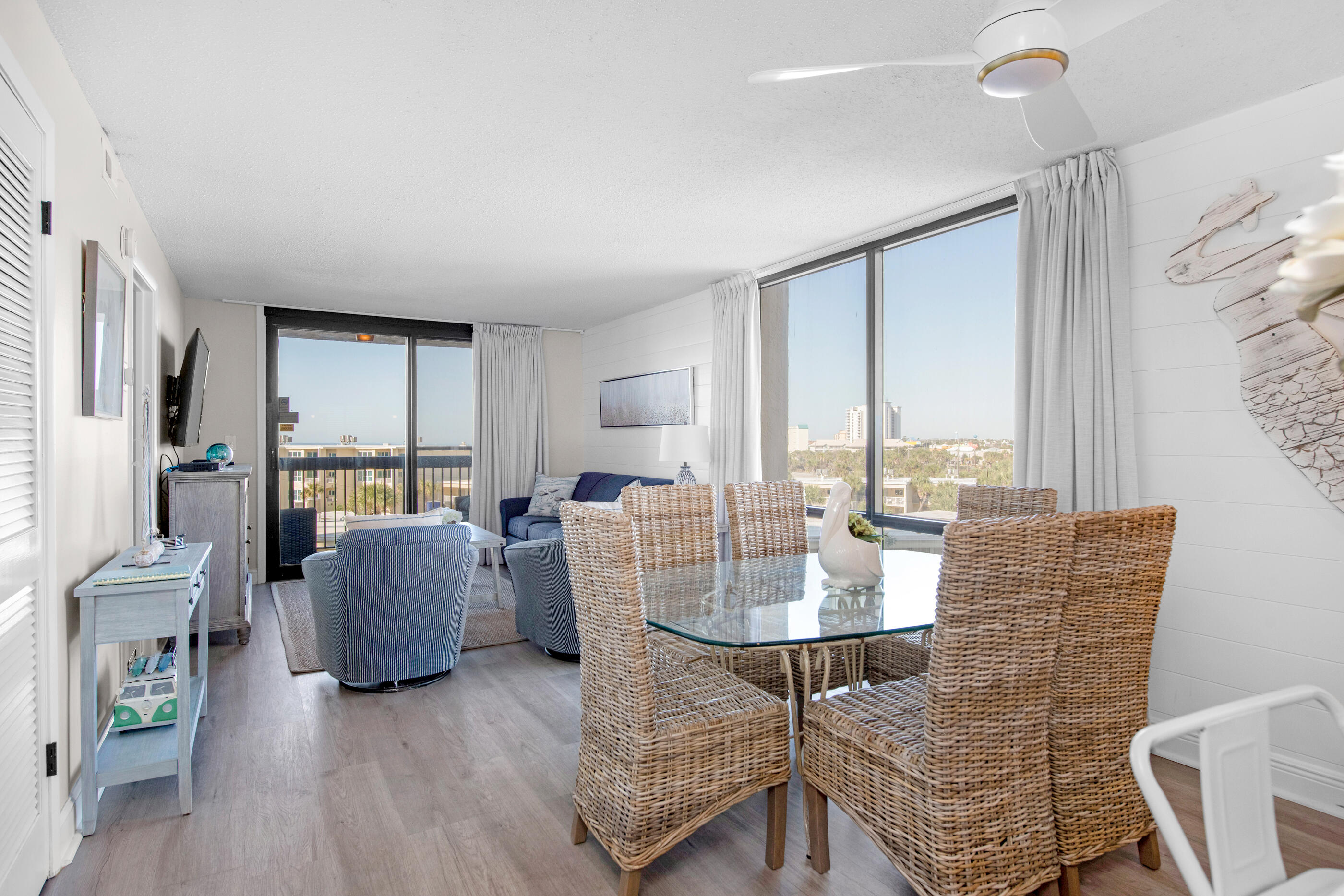 1040 Highway 98, Unit 518 Destin, FL 32541 - Photo 6 of 40 a dining room with furniture a rug and wooden floor
