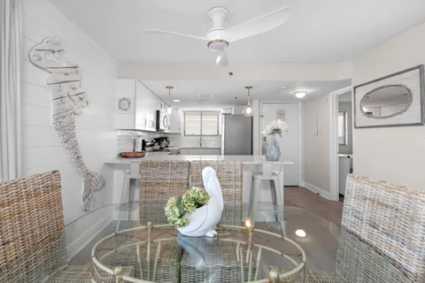 a dining room with furniture and a chandelier