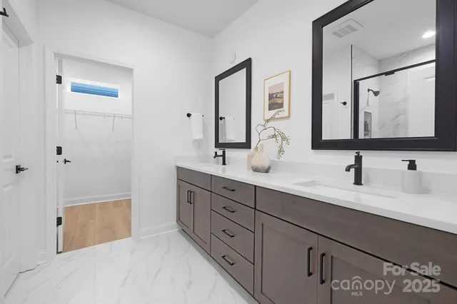 a bathroom with a shower sink and mirror