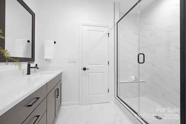 a bathroom with a double vanity sink and window