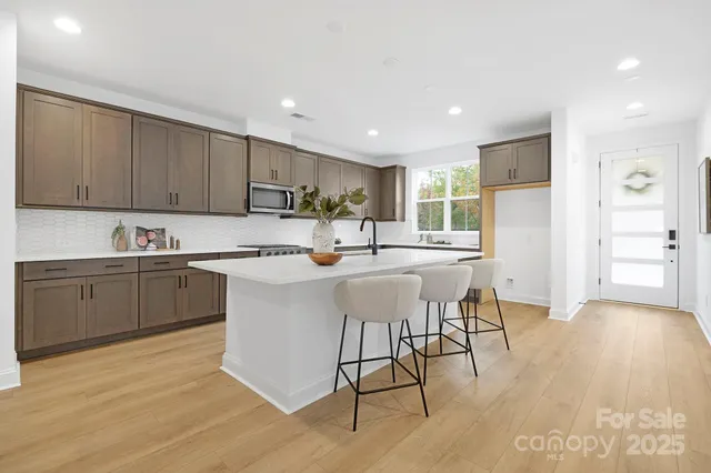 a kitchen with a sink cabinets and wooden floor