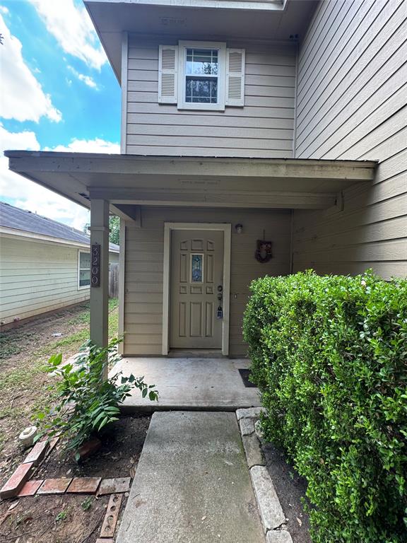 3200 Crownover Street Austin, TX 78725 - Photo 2 of 23 A welcoming front entrance features a covered porch and verdant landscaping.