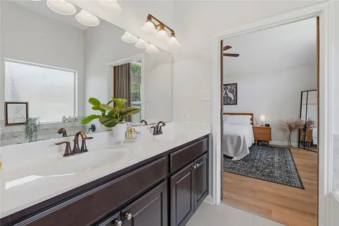 a bathroom with a sink a toilet and mirror