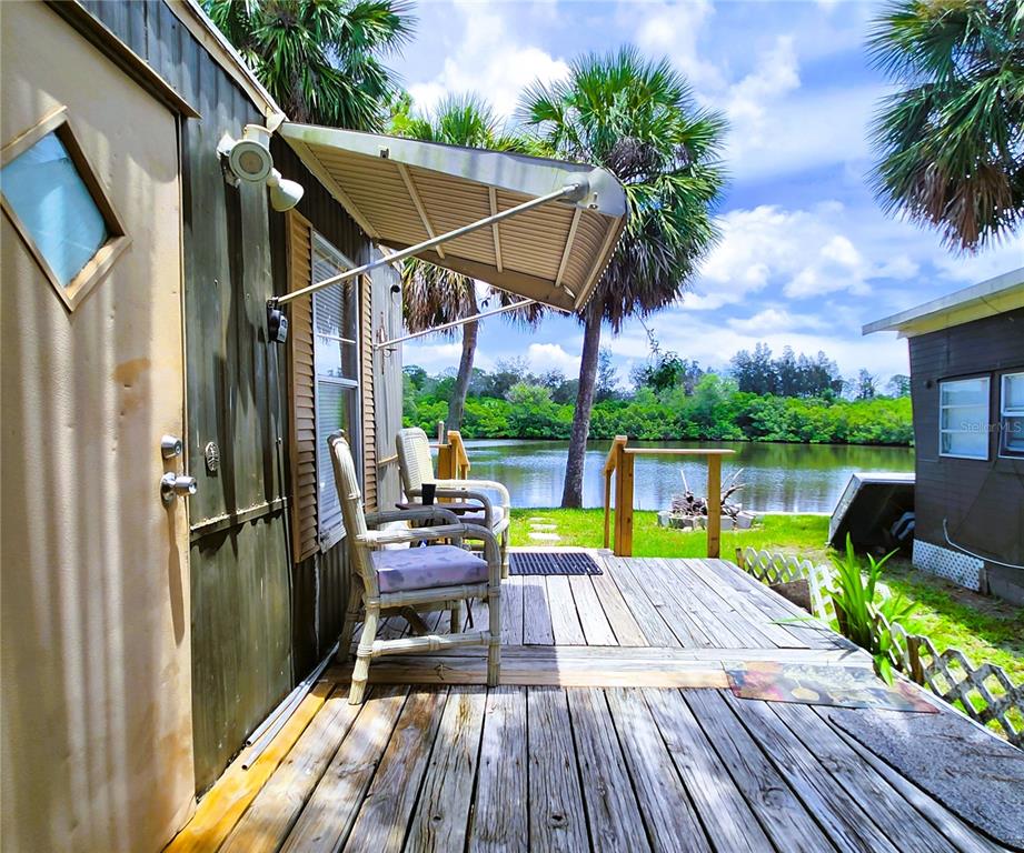 a view of a patio with table and chairs potted plants with wooden floor