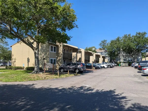a street view with residential house and car parked in front of it