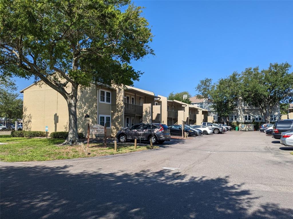 a street view with residential house and car parked in front of it