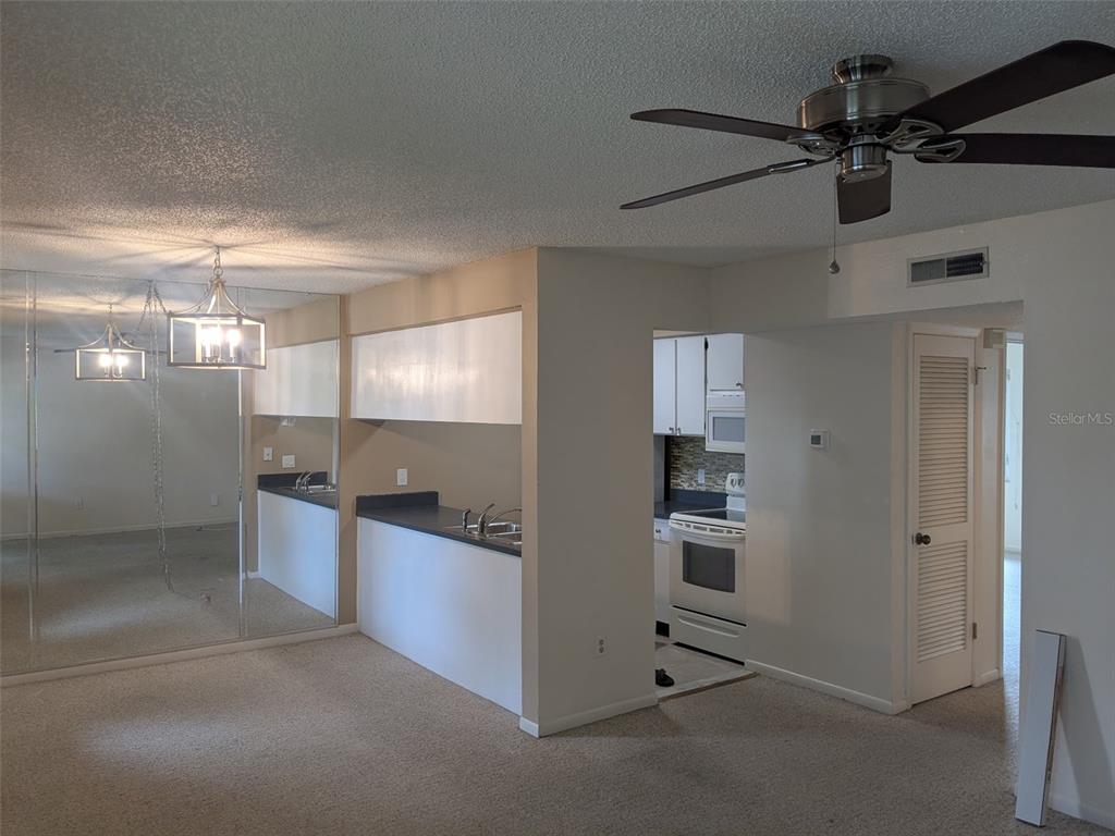 527 South Lincoln Avenue, Unit A208 Tampa, FL 33609 - Photo 3 of 7 a kitchen with stainless steel appliances granite countertop a refrigerator and a sink