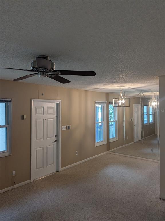 527 South Lincoln Avenue, Unit A208 Tampa, FL 33609 - Photo 4 of 7 a view of a hallway with chandelier and entryway