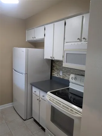 a kitchen with appliances and cabinets
