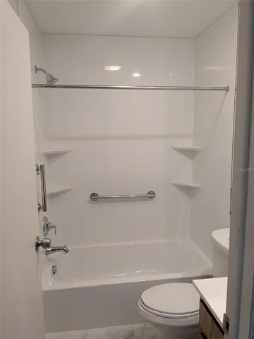 a bathroom with a shower a toilet and sink