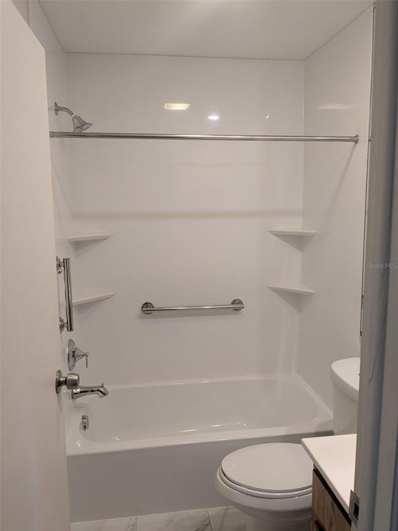 527 South Lincoln Avenue, Unit A208 Tampa, FL 33609 - Photo 6 of 7 a bathroom with a shower a toilet and sink