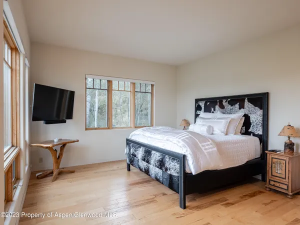 a bedroom with a bed and a flat screen tv