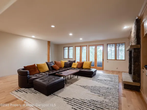 a living room with furniture ceiling fan and a window