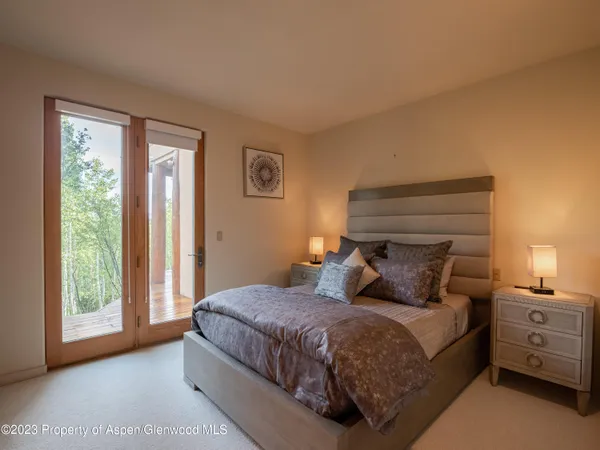 a bedroom with a large bed and a window
