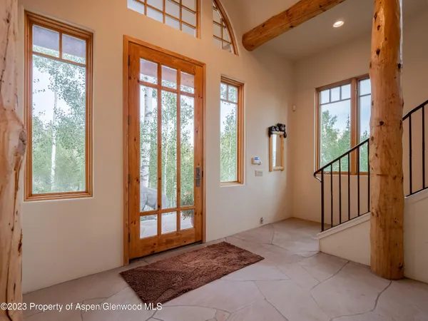 a dining room with furniture entryway and wooden floor