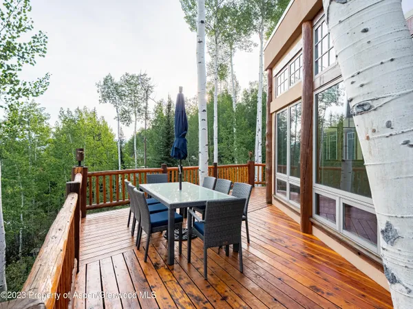 a view of backyard with a deck and hardwood floor