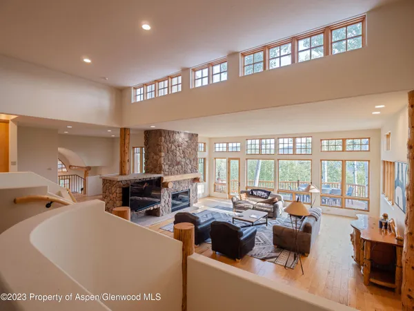 a living room with furniture and large windows