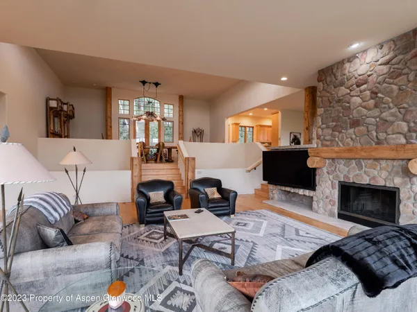 a living room with furniture fireplace and window