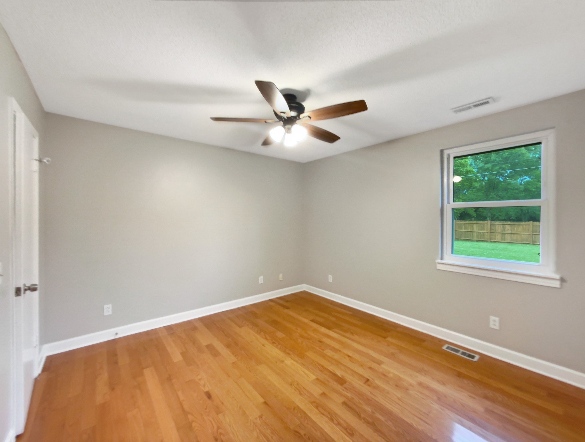 1223 Main Street Pleasant View, TN 37146 - Photo 11 of 20 an empty room with a ceiling fan and window