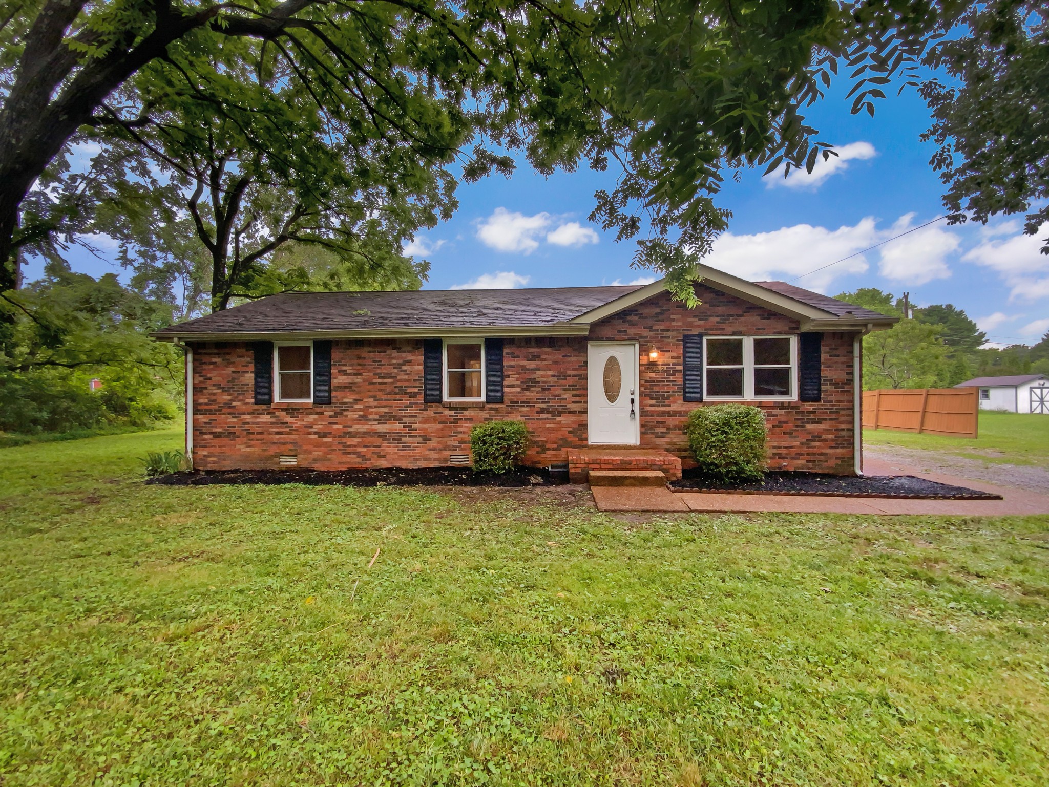 1223 Main Street Pleasant View, TN 37146 - Photo 2 of 20 a front view of a house with garden
