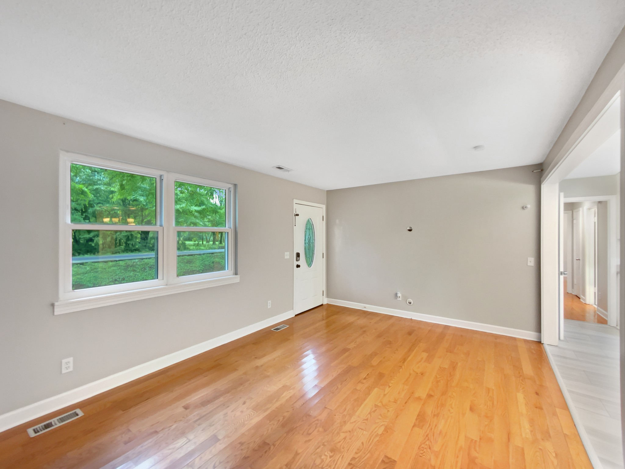 1223 Main Street Pleasant View, TN 37146 - Photo 4 of 20 a view of an empty room with wooden floor and a window