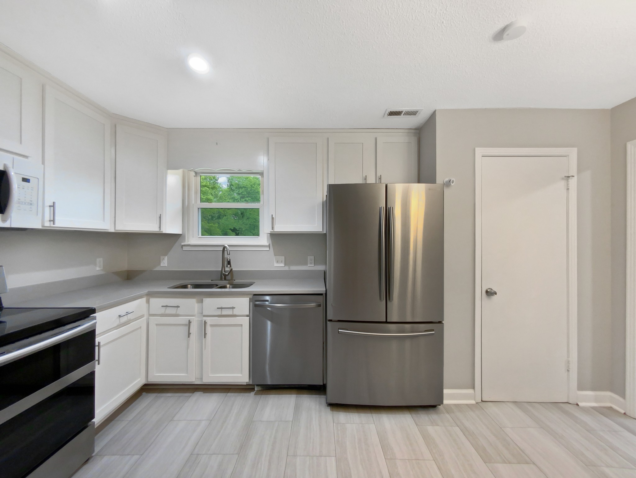 1223 Main Street Pleasant View, TN 37146 - Photo 5 of 20 a kitchen with a refrigerator sink and cabinets