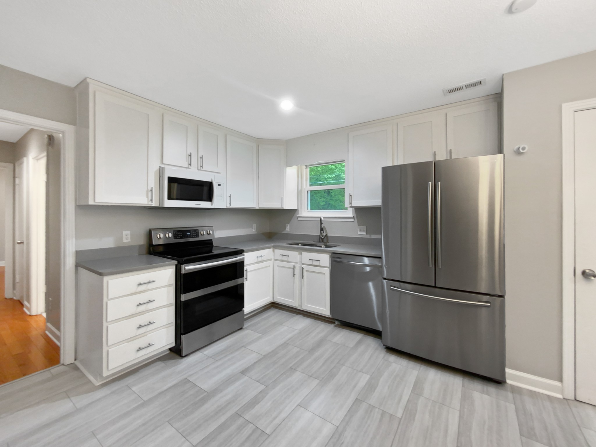 1223 Main Street Pleasant View, TN 37146 - Photo 6 of 20 a kitchen with a refrigerator cabinets and wooden floor