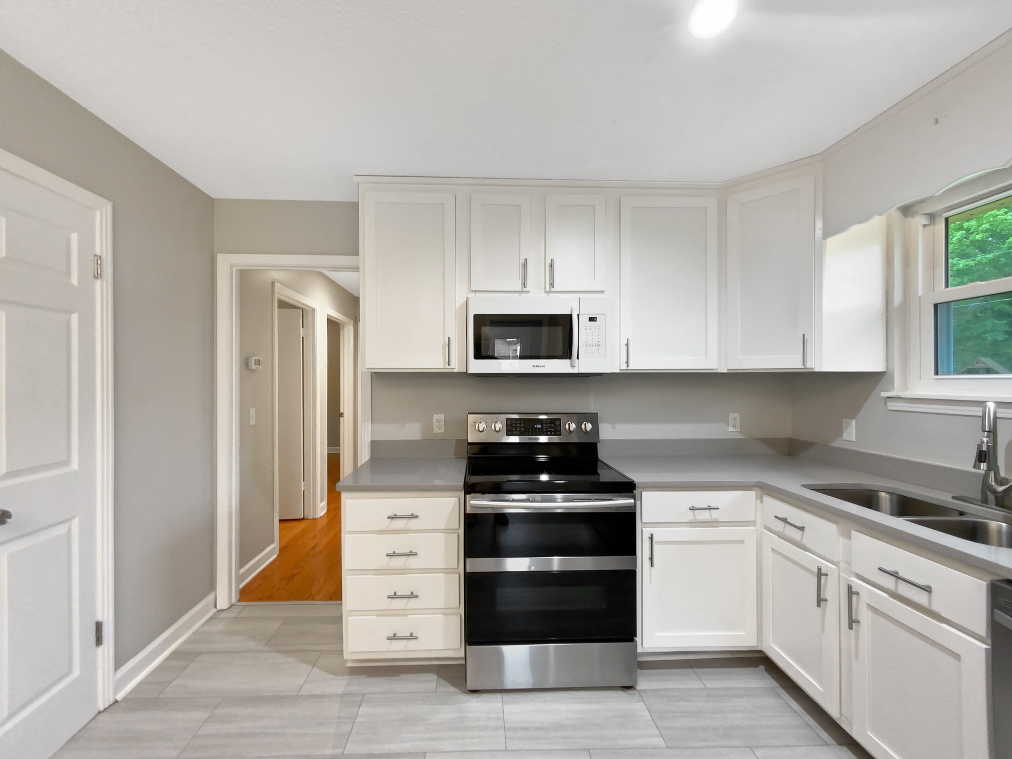 1223 Main Street Pleasant View, TN 37146 - Photo 7 of 20 a kitchen with granite countertop white cabinets and stainless steel appliances