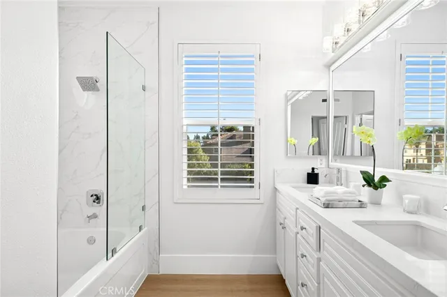 a bathroom with a tub sink and mirror