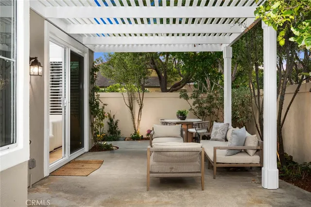a living room with patio furniture and a floor to ceiling window