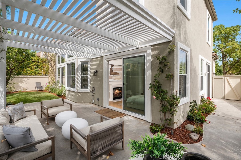 20 Fecamp Newport Coast, CA 92657 - Photo 32 of 35 a view of a patio with couches table and chairs potted plants and floor to ceiling window