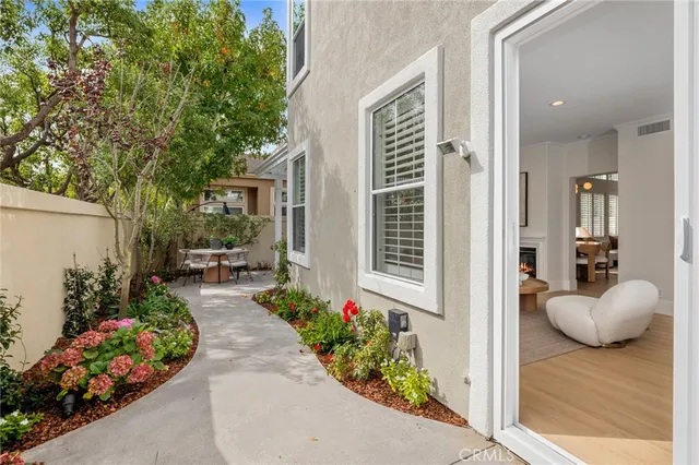 a view of a porch with flowers potted plants
