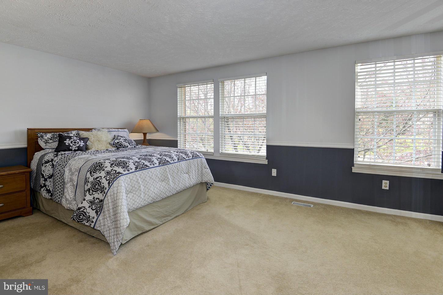 1511 Autumn Ridge Circle Reston, VA 20194 - Photo 11 of 29 a bed sitting in a bedroom next to a window