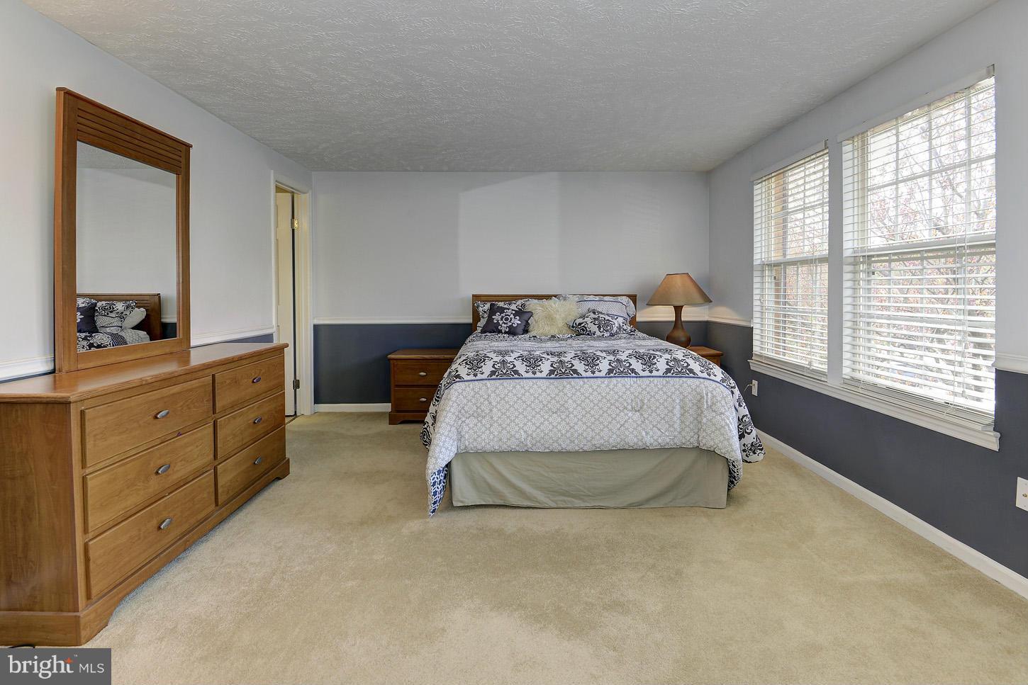 1511 Autumn Ridge Circle Reston, VA 20194 - Photo 12 of 29 a bedroom with a bed and large windows