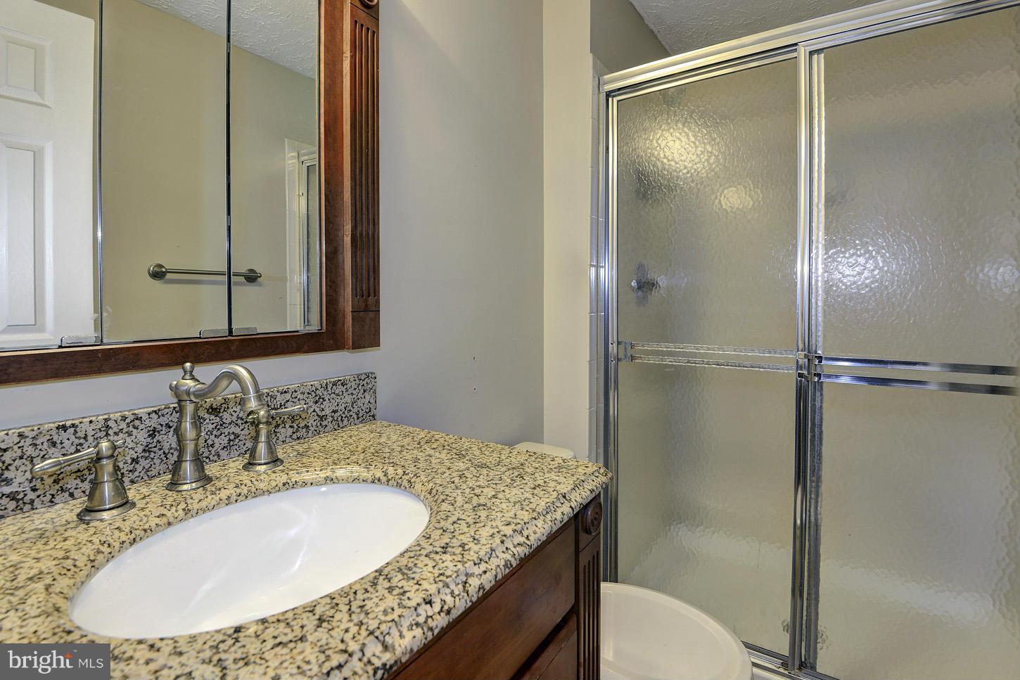 1511 Autumn Ridge Circle Reston, VA 20194 - Photo 13 of 29 a bathroom with a granite countertop sink toilet and shower