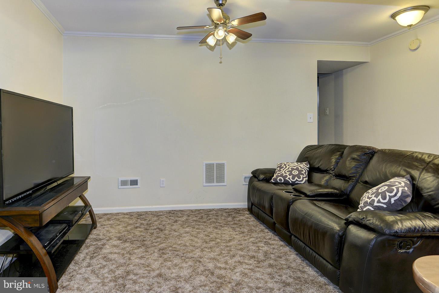 1511 Autumn Ridge Circle Reston, VA 20194 - Photo 19 of 29 a living room with furniture a flat screen tv and a rug