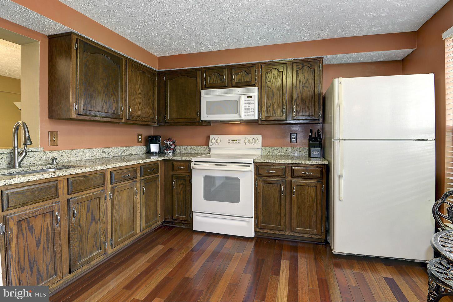1511 Autumn Ridge Circle Reston, VA 20194 - Photo 3 of 29 a kitchen with a white cabinets and white appliances