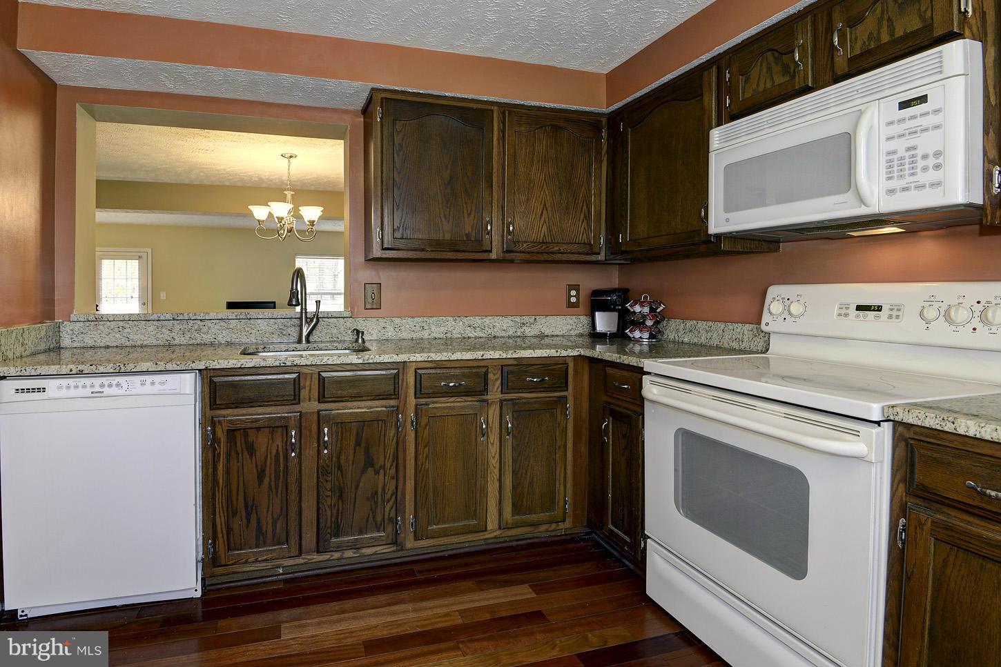 1511 Autumn Ridge Circle Reston, VA 20194 - Photo 4 of 29 a kitchen with stainless steel appliances granite countertop a sink a stove and cabinets
