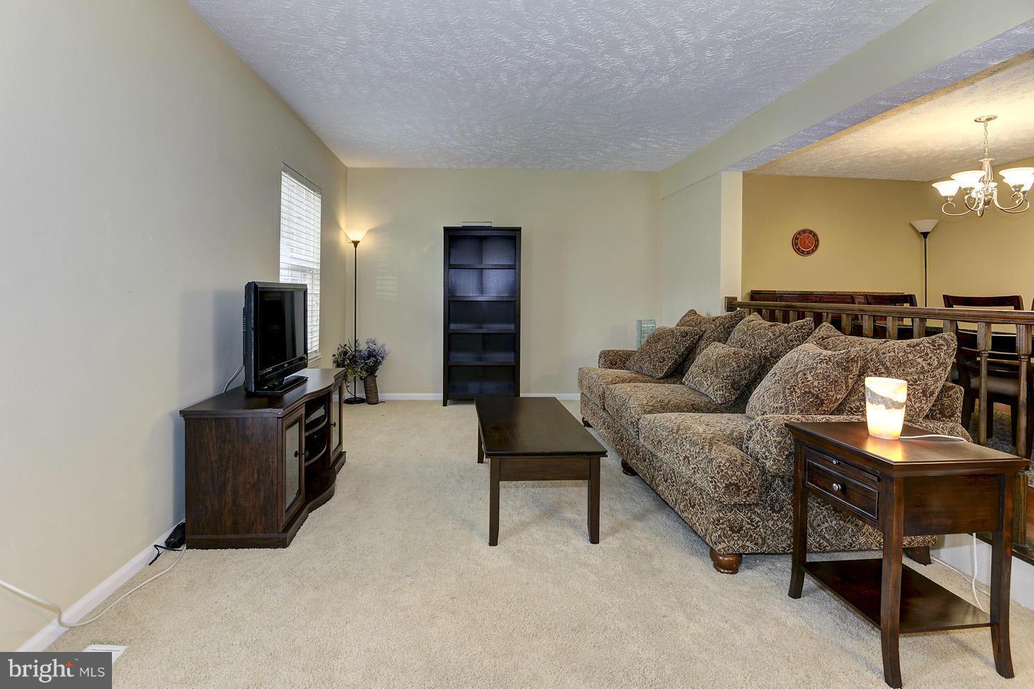 1511 Autumn Ridge Circle Reston, VA 20194 - Photo 9 of 29 a living room with furniture and a flat screen tv