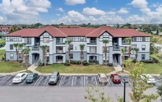 an aerial view of a house with swimming pool and furniture
