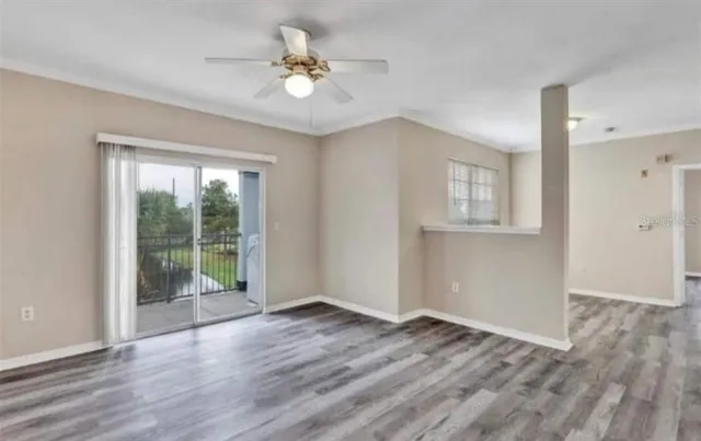 a view of an empty room with glass door and balcony