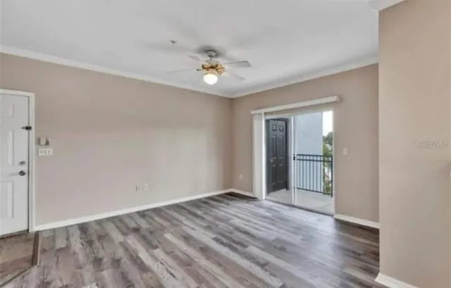 wooden floor in an empty room with a window