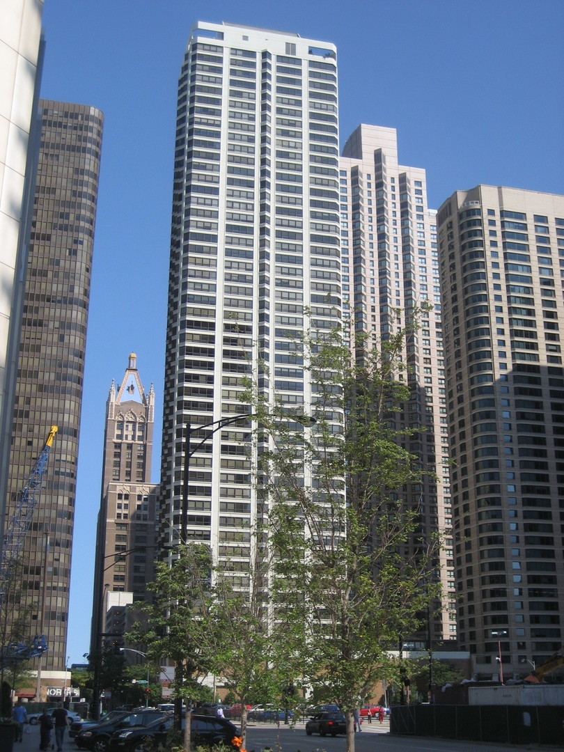 a view of a building with tall trees