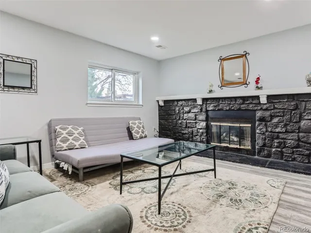 a living room with furniture a rug and a fireplace