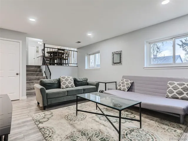 a living room with furniture and a rug